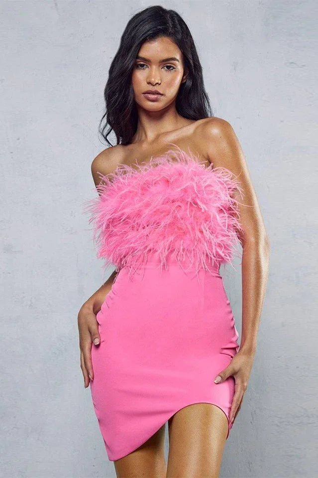 Woman in pink strapless dress with feather trim and asymmetrical hem, front view. Main image