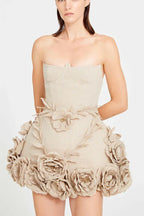 Woman in a cream corset dress with lace-up detail and flared skirt