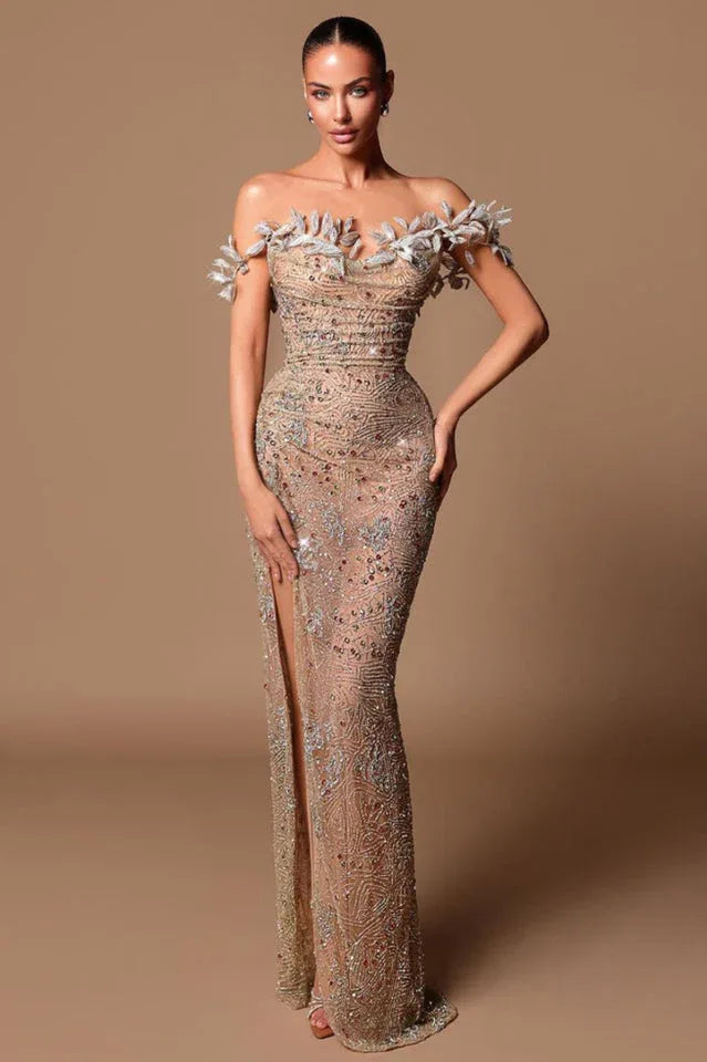 Woman in a shimmering nude beaded gown with a high slit and off-the-shoulder floral detail Main image