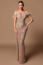 Woman in a shimmering nude beaded gown with a high slit and off-the-shoulder floral detail