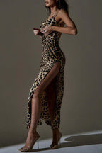 Woman adjusting her leopard print satin slip dress with a high slit