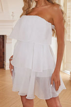 Front detail of a white strapless tiered chiffon dress