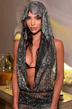 Close-up of a woman in a hooded, sparkling mesh top, showcasing the intricate embellishments.