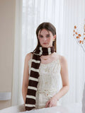 Woman wearing a long black and white striped knit scarf with ruffle edges - View 14 | WEUXS