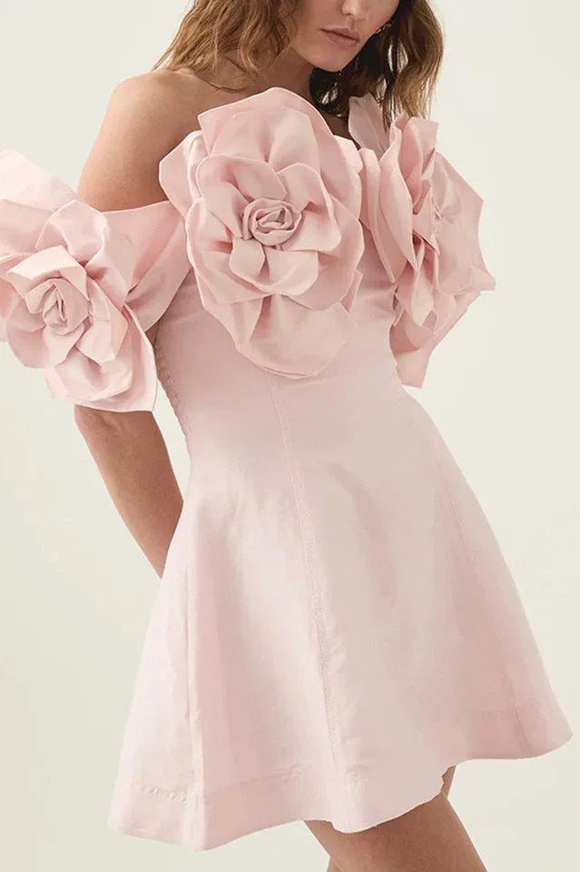 Close-up of the light pink dress showcasing the intricate floral details on the shoulder area.