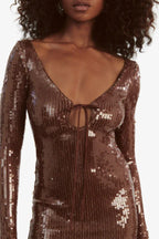 Close-up of the tie-front neckline and sequin detail on a brown dress.