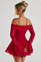 Back view of a woman in a red off-the-shoulder dress with a tiered skirt