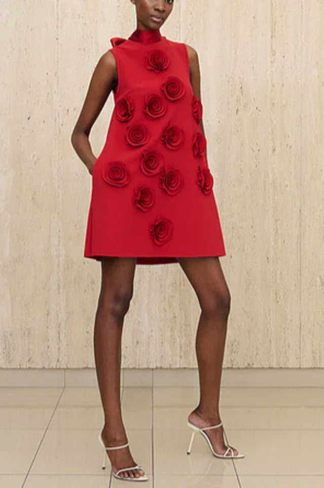 Red sleeveless A-line dress with 3D rose embellishments and pockets, worn by a model with white heels.