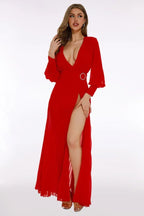 Front view of a red chiffon evening gown with a ring detail at the waist and bishop sleeves.