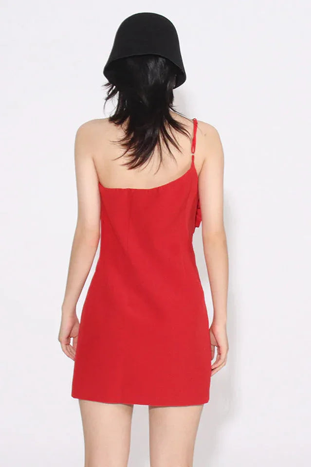 Back view of a woman wearing a red one-shoulder sheath dress