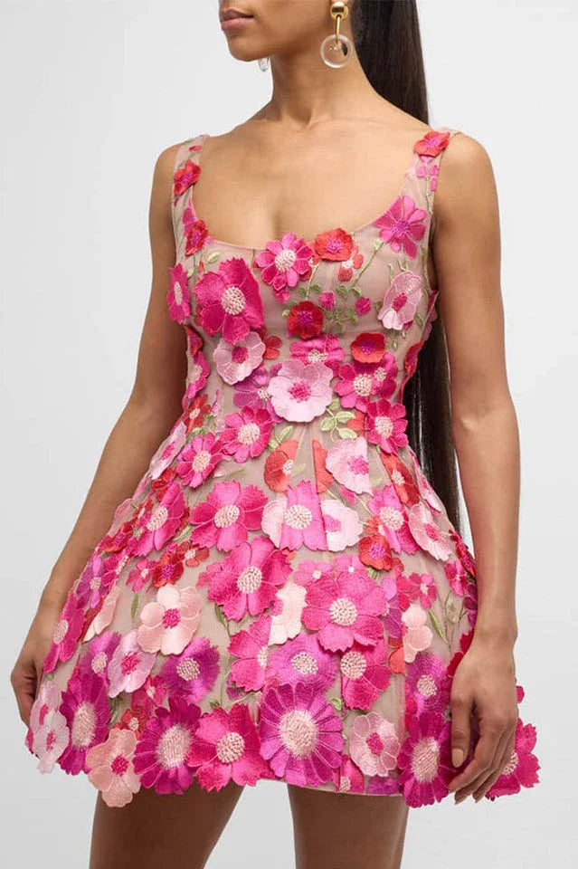 Woman wearing a pink floral embroidered mini dress from the front Main image