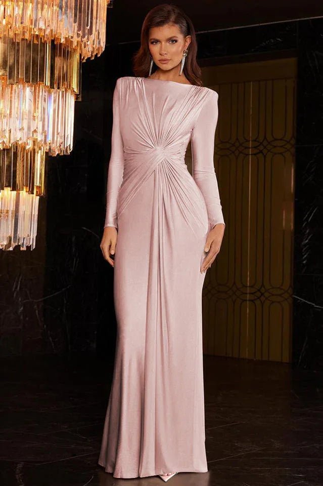Woman in a long-sleeved, ruched pink satin gown with a dramatic chandelier.