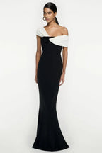 Back view of a woman in a black and white formal gown with a mermaid silhouette