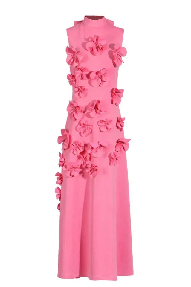 Pink sleeveless maxi dress with scattered floral appliqués, displayed on a mannequin.