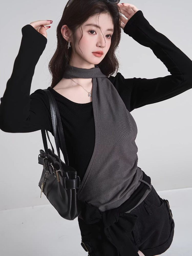 Side profile of the black long-sleeve top with grey fabric detail