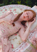Close-up of the floral print on a pink midi dress.