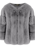 Close-up of a grey faux fur jacket with a textured sleeve design and a v-neck.