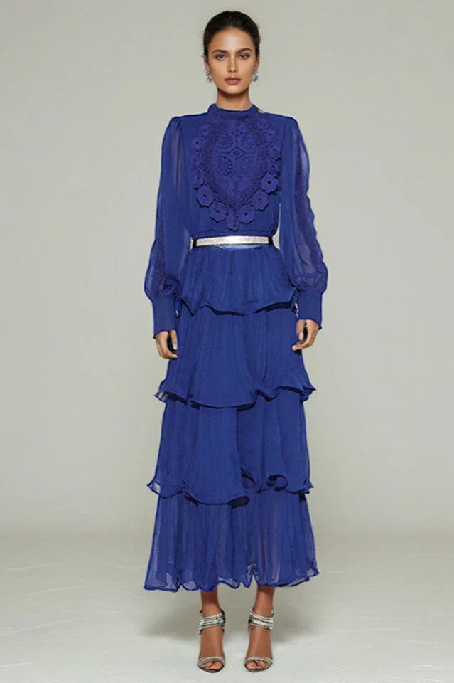 Woman wearing a royal blue tiered chiffon maxi dress with lace detail and balloon sleeves