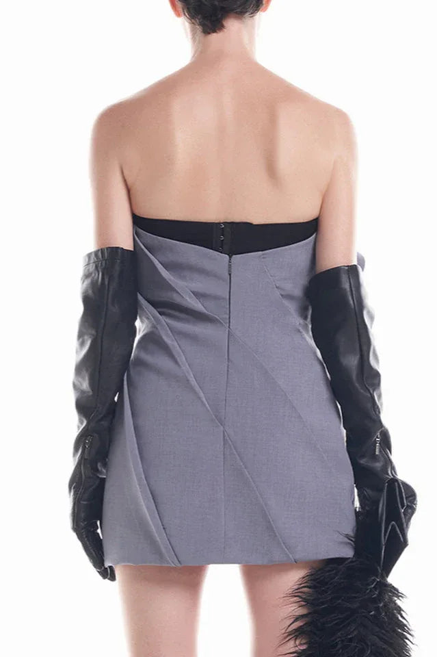 Back view of the grey strapless mini dress, showing a zipper closure and pleated detailing.