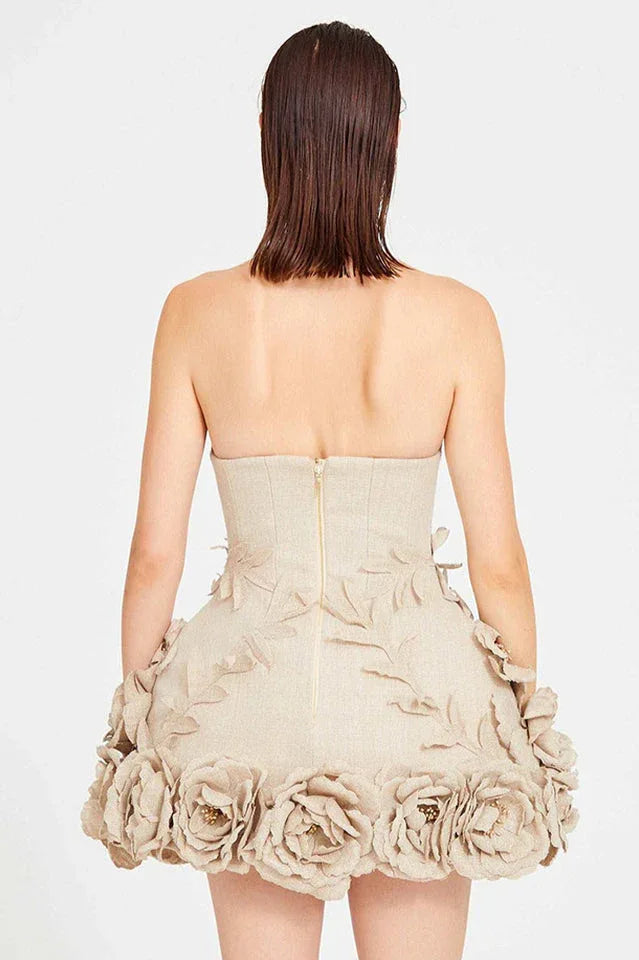 Side view of a woman in a cream strapless corset dress