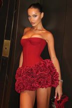 Woman in a red strapless corset dress with a ruffled skirt