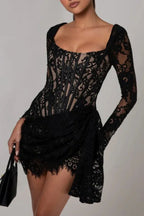 Woman wearing a black lace mini dress with a square neckline and long sleeves.