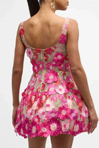Woman wearing a pink floral embroidered mini dress from the back