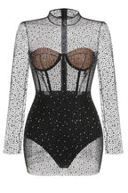 Detailed view of the structured bodice on a black mesh dress