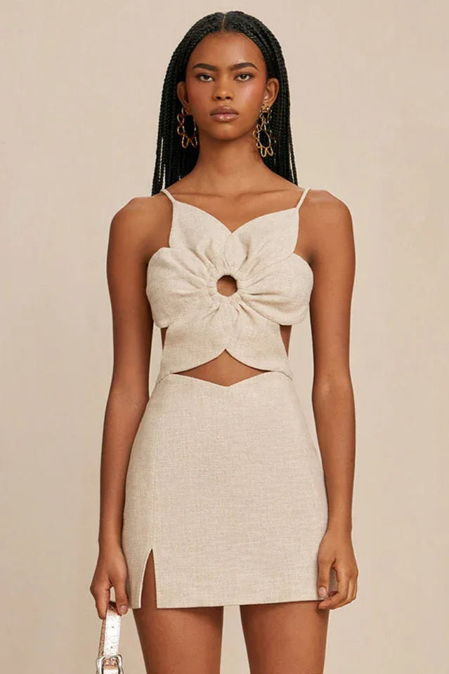 Woman wearing a beige linen blend sleeveless dress with a flower-shaped bodice and cut-out detail. Main image