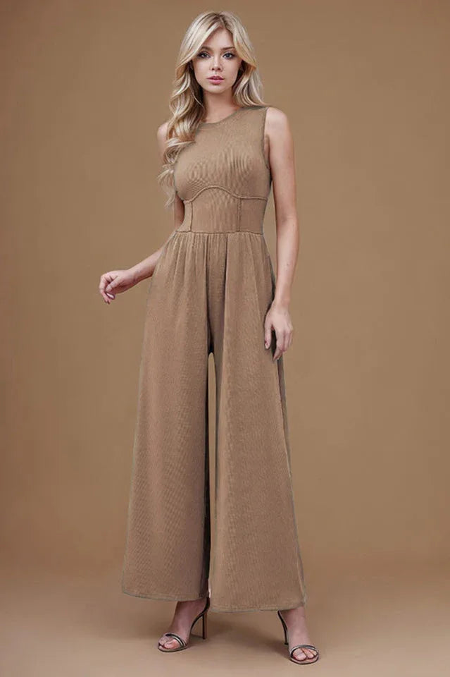 woman wearing a sleeveless wide leg jumpsuit in taupe