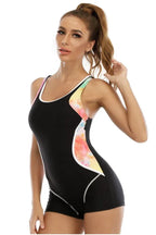 Side view of a woman in a black athletic swimsuit with tie-dye accents