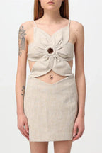 Close-up of a beige linen blend dress with a flower-shaped bodice and cut-out detail.