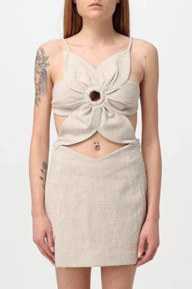 Close-up of a beige linen blend dress with a flower-shaped bodice and cut-out detail.