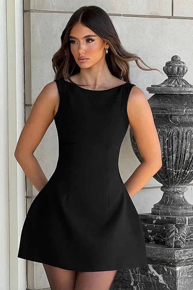 woman wearing a black mini dress with spaghetti straps and a square neckline