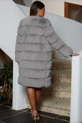 Back view of a grey tiered faux fur coat