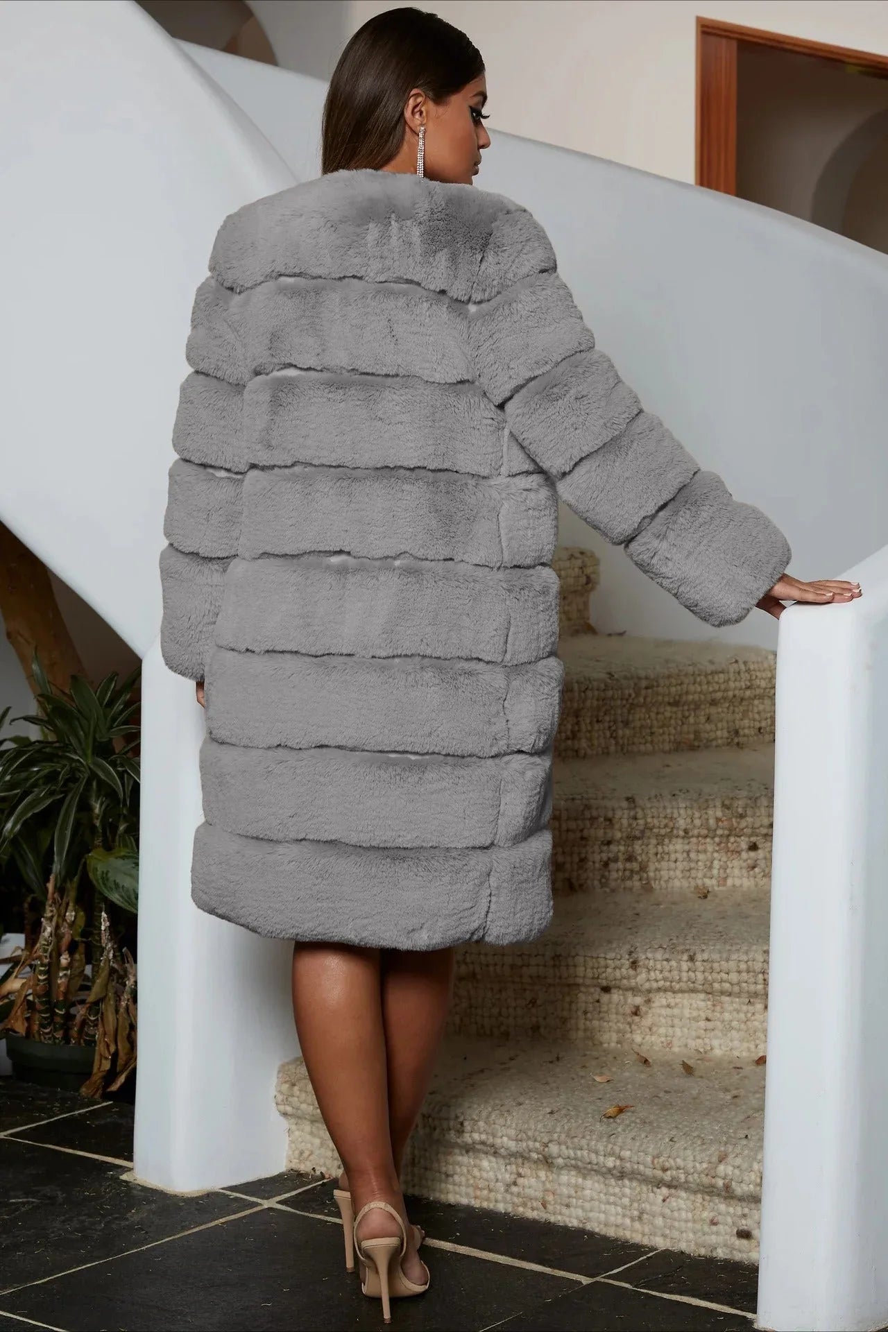 Back view of a grey tiered faux fur coat