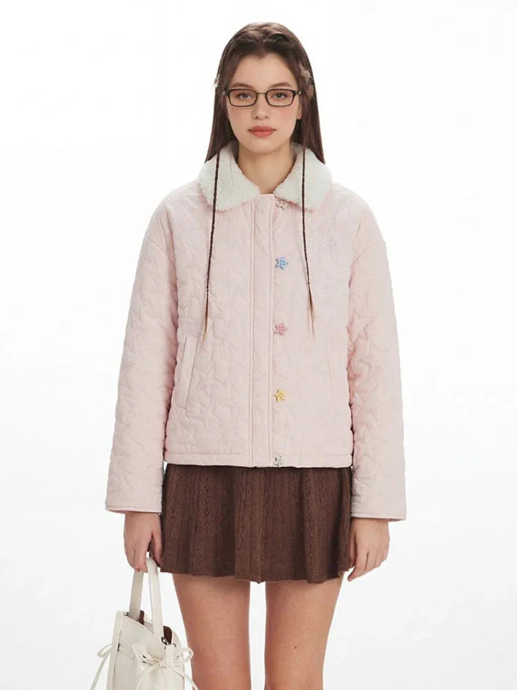Close-up of the pink quilted jacket featuring embellished buttons and faux fur collar.