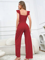 Woman in red textured lounge set, back view