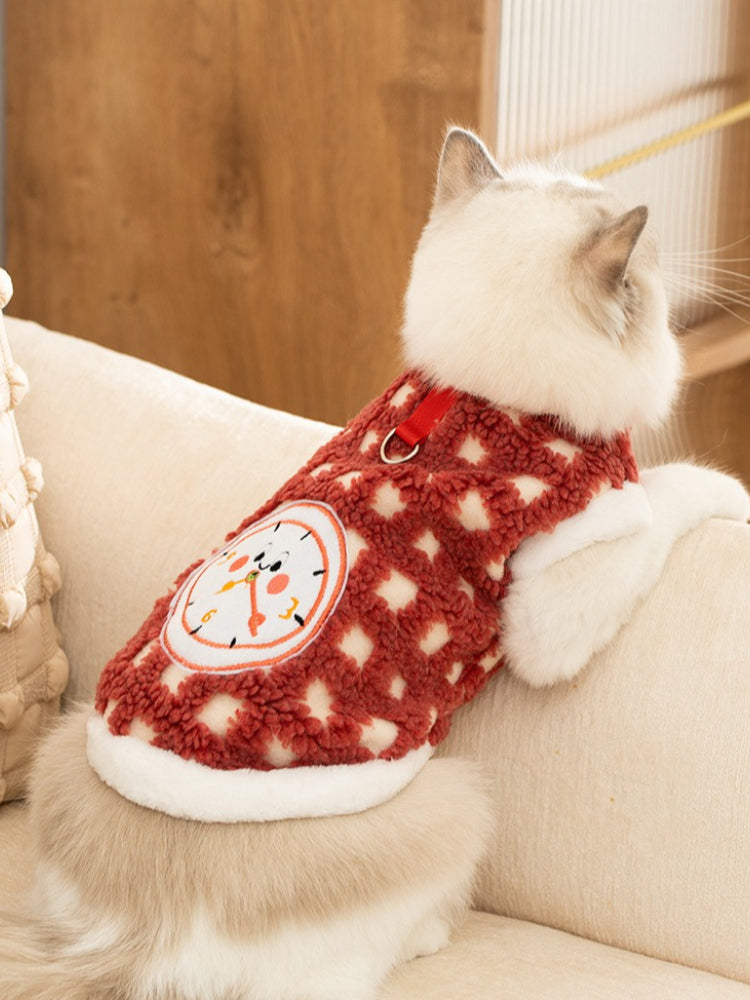Ragdoll cat wearing a red and white checkered fleece pet vest with a white collar
