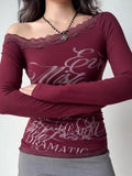 Woman in a burgundy long sleeve off-the-shoulder top with lace trim and graphic print