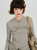 Front view of the grey ribbed knit hooded long sleeve top with a graphic embellishment.
