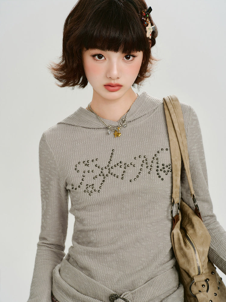 Front view of the grey ribbed knit hooded long sleeve top with a graphic embellishment.