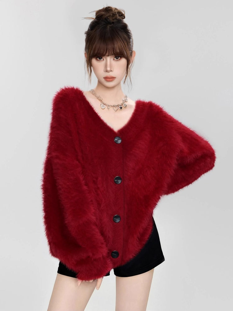 Woman wearing a red fuzzy V-neck button-down cardigan