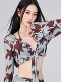 Close-up of the floral print tie-front sheer top.