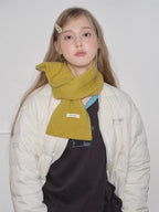 yellow knitted scarf wrapped around neck