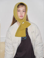 yellow knitted scarf worn as hood