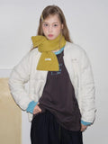 yellow knitted scarf tied in bow