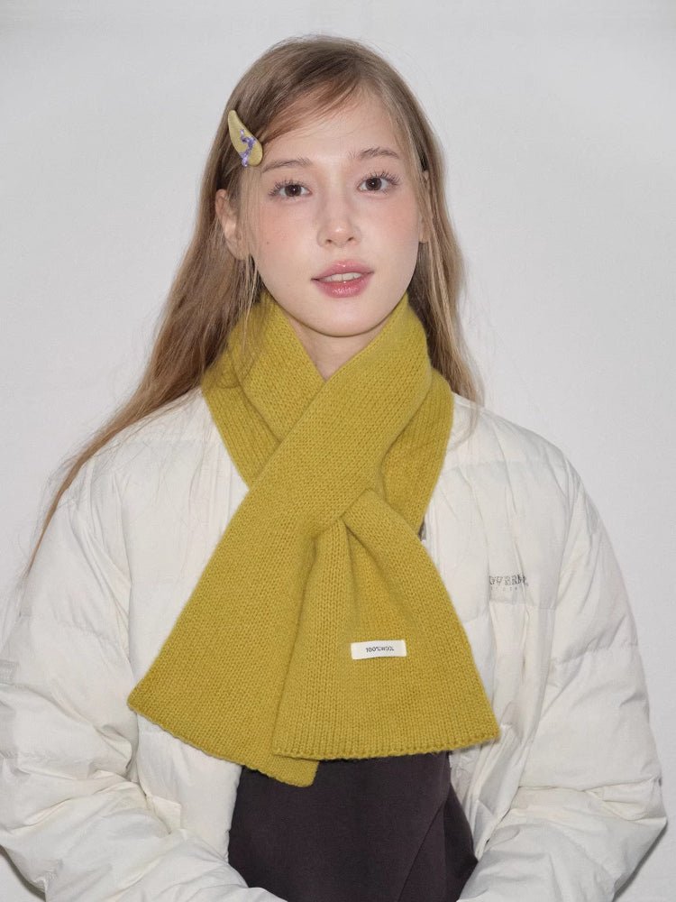 yellow knitted scarf styled around neck