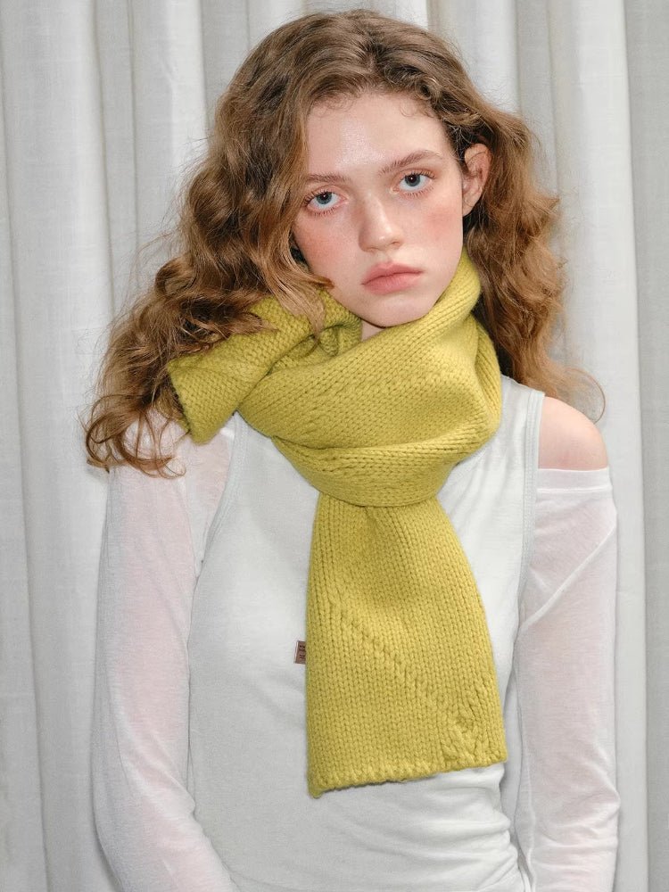 Model wearing yellow knitted scarf with textured pattern