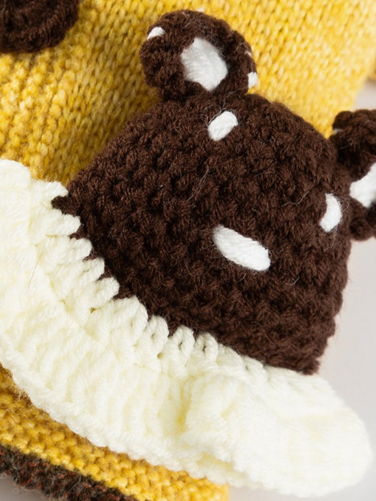 Close-up of the crocheted bear applique on the yellow knitted pet sweater.